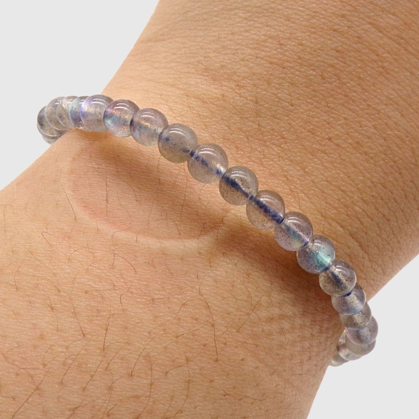 Labradorite beaded bracelet worn on the wrist on a white background