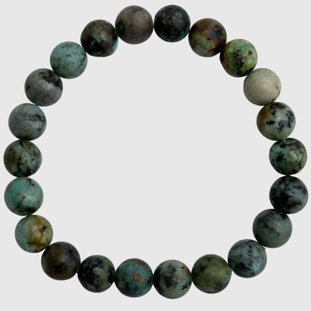 African Turquoise round beaded bracelet with dark teal stones on a white background