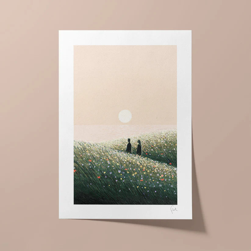 Framed artwork of two silhouettes in a field with a sunset on a beige wall.