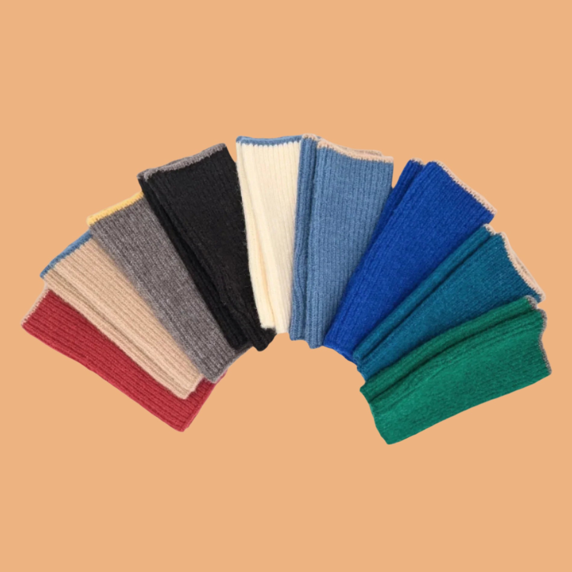 nine pairs of handwarmers side by side on white background